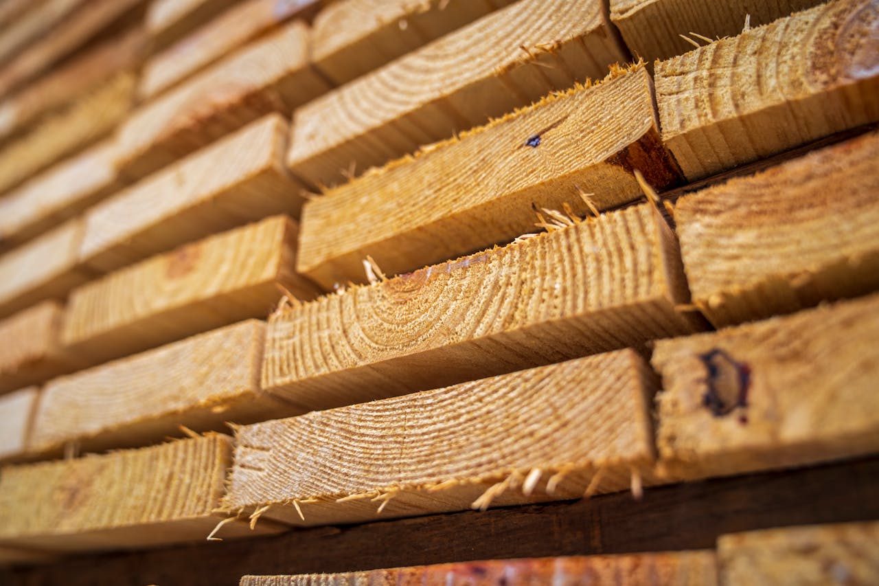 Detailed close-up of neatly stacked wooden planks showing textures of natural lumber.